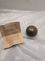 Spherical container closed beside pamphlet
