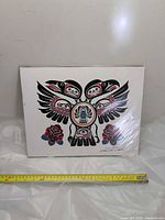 Full view of matted Haida style print with measuring tape for scale