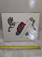 Full view of Haida hummingbird and rose art print with tape measure indicating width