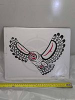 Front of Haida owl print with tape measure showing width