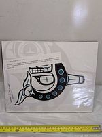 Front view showing Haida orca design and scale