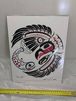 Front view of signed Haida print with ruler for scale