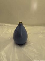 Full view of glossy sky blue ceramic bud vase