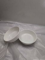 Two white opal Pyrex bowls side by side
