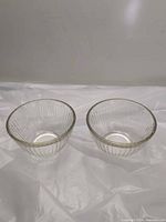 Pair of clear ribbed Pyrex bowls side by side