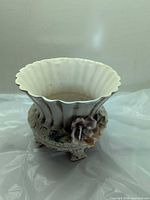 Overall view showing scalloped rim and floral appliqué