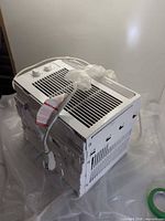 Three-quarter view of full unit showing exterior casing, control panel, power cord