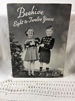 Beehive Eight to Twelve Years knitting pattern booklet cover showing two children with dog