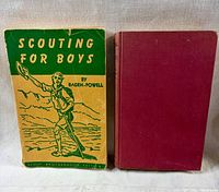 Front view of both books: Scouting for Boys with illustrated cover and Riveting for Success red cloth hardcover