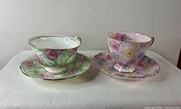 Both teacup and saucer sets side by side