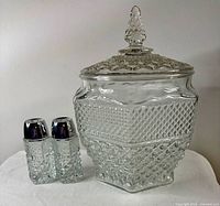 Cookie jar with lid beside salt and pepper shakers