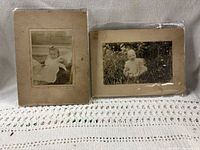Two mounted sepia photographs of infants