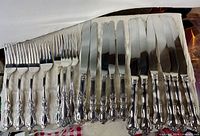 Assorted forks and knives in flatware roll