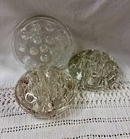 All three clear glass flower frogs grouped together