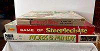 Stack of three board games showing spines