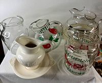 Group view of five pitchers and saucer