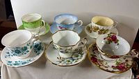 Group shot of all six teacup and saucer sets