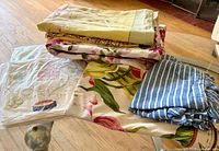 Stack of assorted floral and striped pillowcases, one in plastic