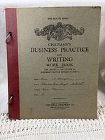 Front cover showing title, crest, red spine, ring posts