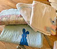 Stack showing all four baby linens folded