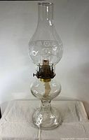 Full view of clear glass hurricane lamp