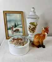 Group shot showing all four items: fox figurine, rabbit vase, trinket dish, framed picture