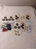 All button packages displayed on white cloth showing card fronts and loose bag