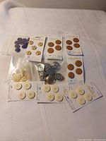 All ten button packages laid out on cloth background