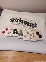 All 16 button packages laid out on table