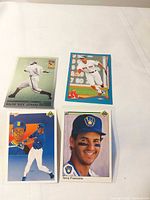 All four baseball cards laid out on table: Buck Leonard, Xander Bogaerts, Mariners player, Brewers player