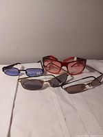 All four pairs of sunglasses displayed on white surface