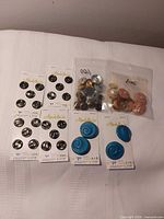 Overview of all eight button packages on bedspread