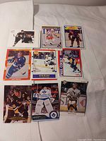 Nine NHL cards laid out 3×3 on bed