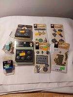 All eight sealed embellishment packs laid out on surface