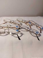 All six pairs of reading glasses on white surface