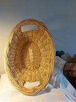 Top view of oval wicker basket showing weave pattern, base and side handles