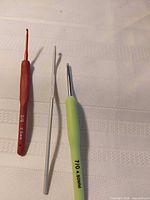 Three crochet hooks side by side showing sizes and colours