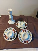 Group shot showing candle holder and three egg cup plates