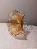 Top angle showing ruffled rim and iridescent surface