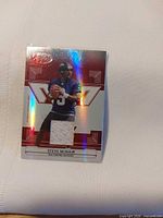 Front of Steve McNair Baltimore Ravens jersey card showing player image, embedded jersey swatch and holographic finish