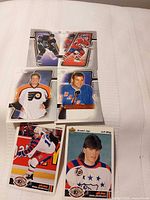 Six hockey cards laid out showing fronts
