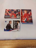 Three hockey cards laid out: Barkov, Hall, Koivu