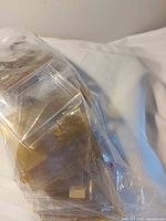 Bag containing stack of hard plastic card savers, some yellowed