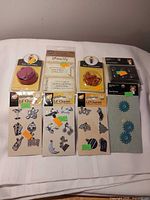 All eight unopened scrapbook accessory packages laid out