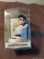 Front view of boxed solar dancing Elvis figure
