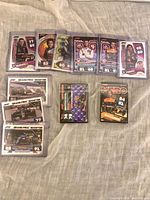 Sleeved 2022 Topps F1 cards showing drivers George Russell, Yuki Tsunoda, Lando Norris, Mick Schumacher, Daniel Ricciardo and others