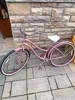 Full side view of pink cruiser bicycle
