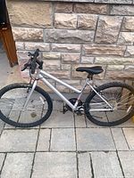 Full left side view of silver mountain bike