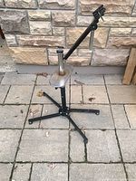 Full view of repair stand showing four-leg base, column, arm, clamp and tray