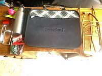 All items laid out: bag, rack, bottle, bell, reflector, bottle cage, bungee pack, tripod stand